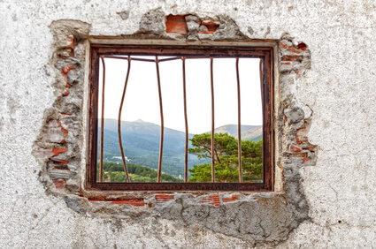Window red bars on a white wall and demolished with forest view